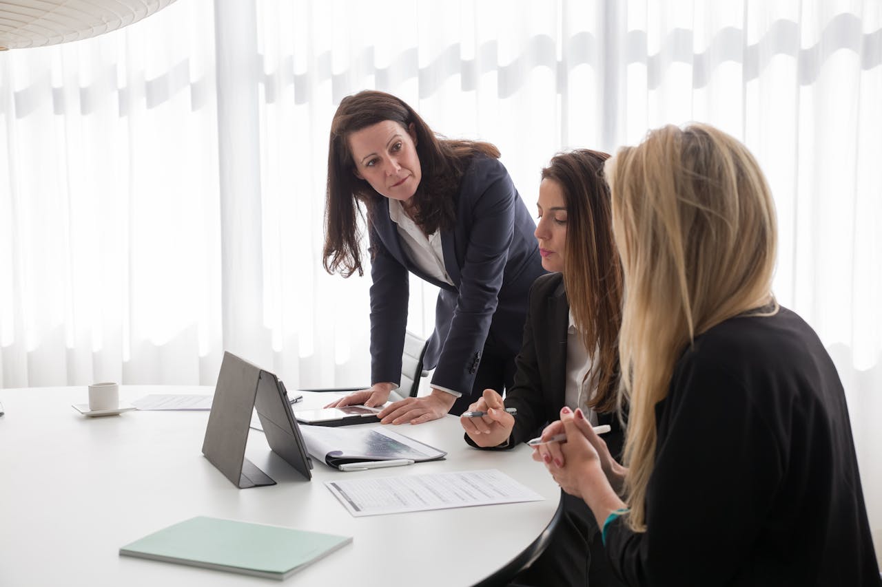 Three women working in an office. Business grants for women with no revenue.