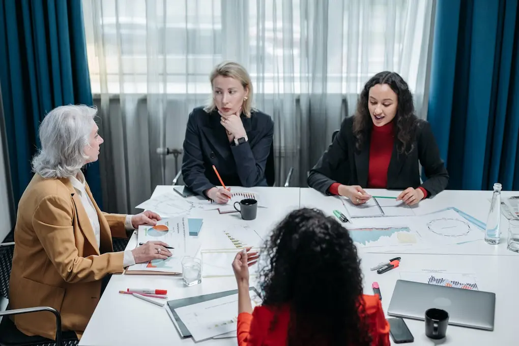 Businesswomen having a meeting in an office. Business grants for women in Pennsylvania.