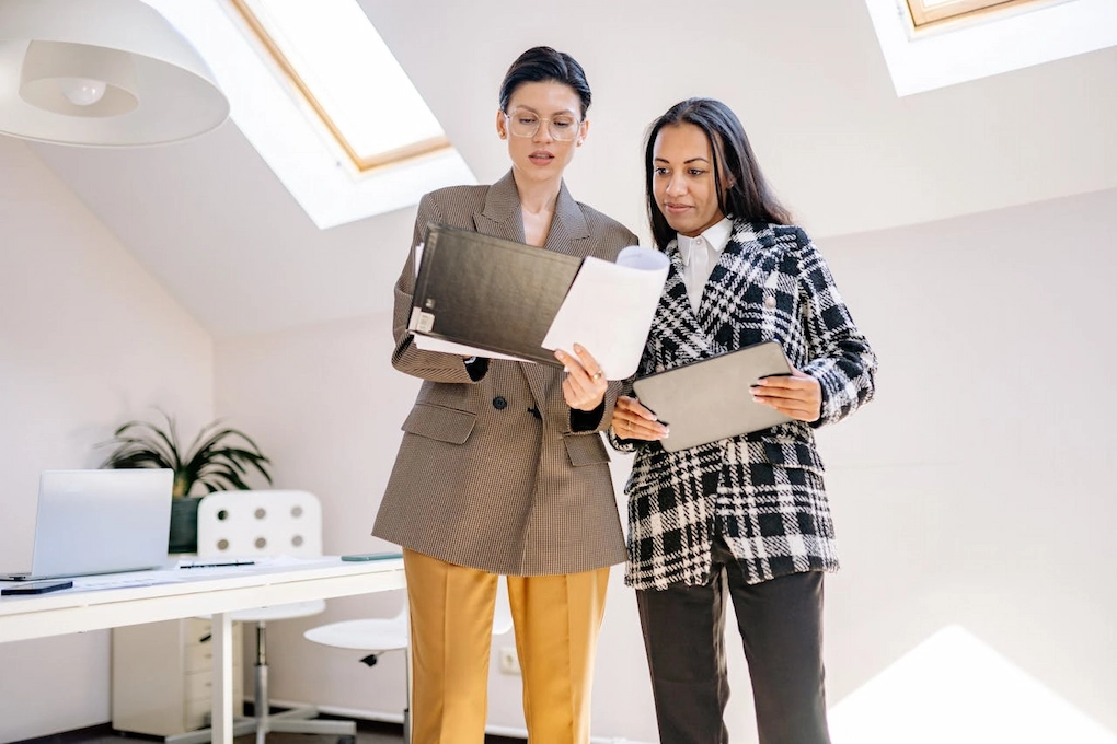 Two women staring at a document. How to Structure a Business Plan That Attracts Funding
