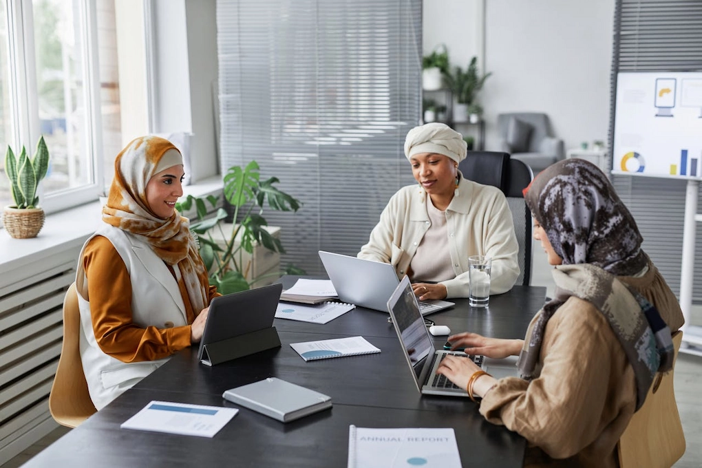 Three women working in an office. How to explain the 'use of funds' in business grant applications