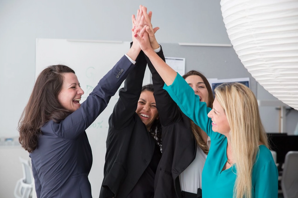 Happy businesswomen celebrating success. Hidden costs of applying for business grants