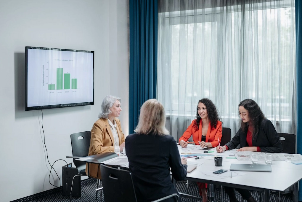 Four women discussing business. Amber Grant application mistakes to avoid