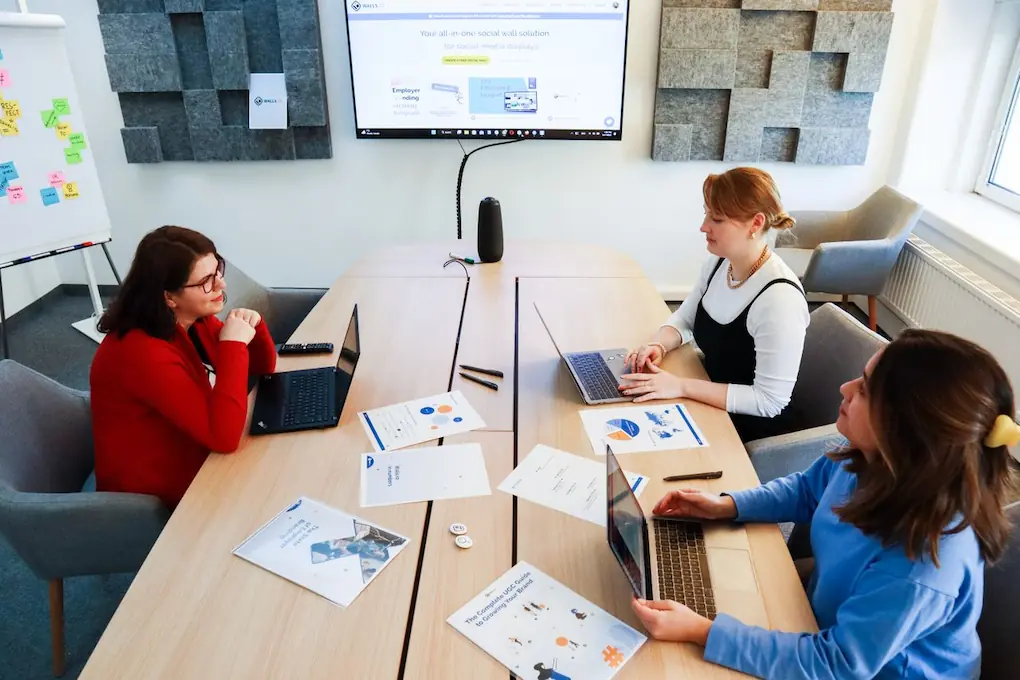 Women discussing business at a conference table. Tips for Amber Grant application