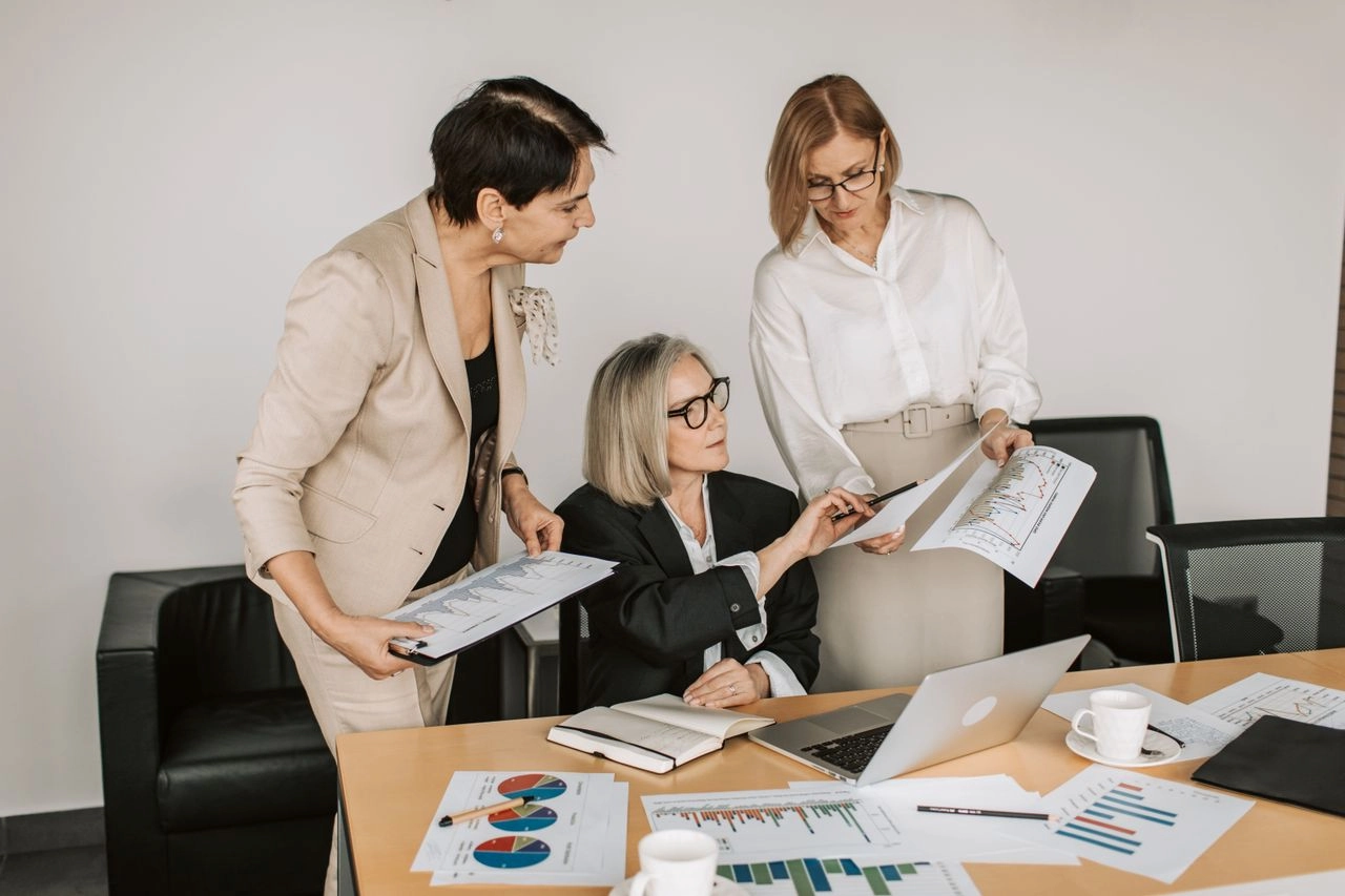 Three women discussing business in the office.
