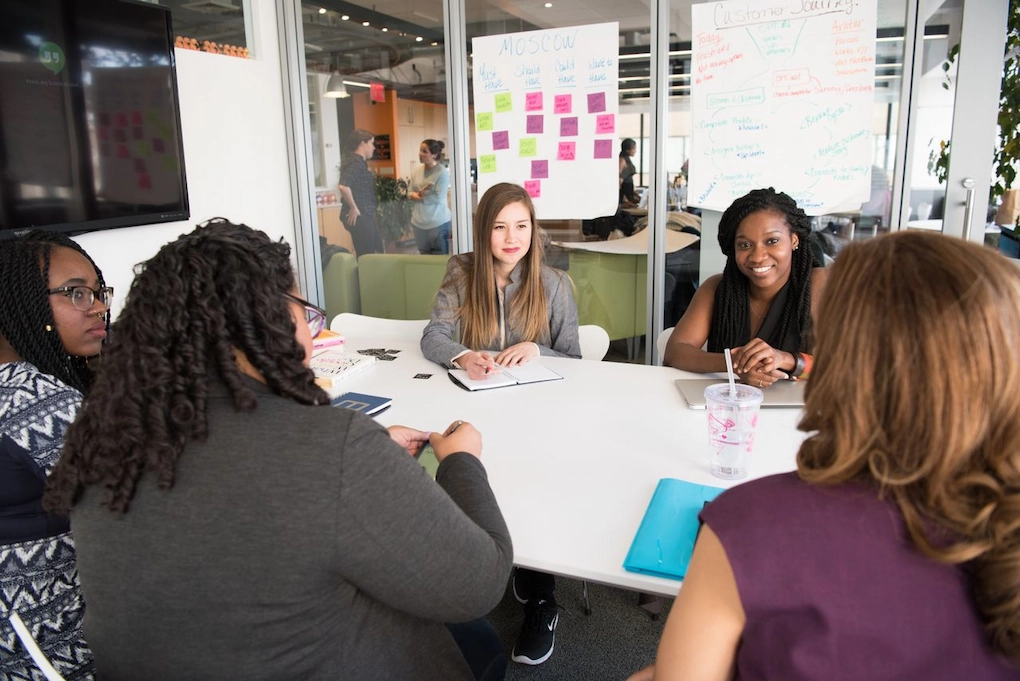 A group of women working together in an office. Small business grants for women in New Jersey.