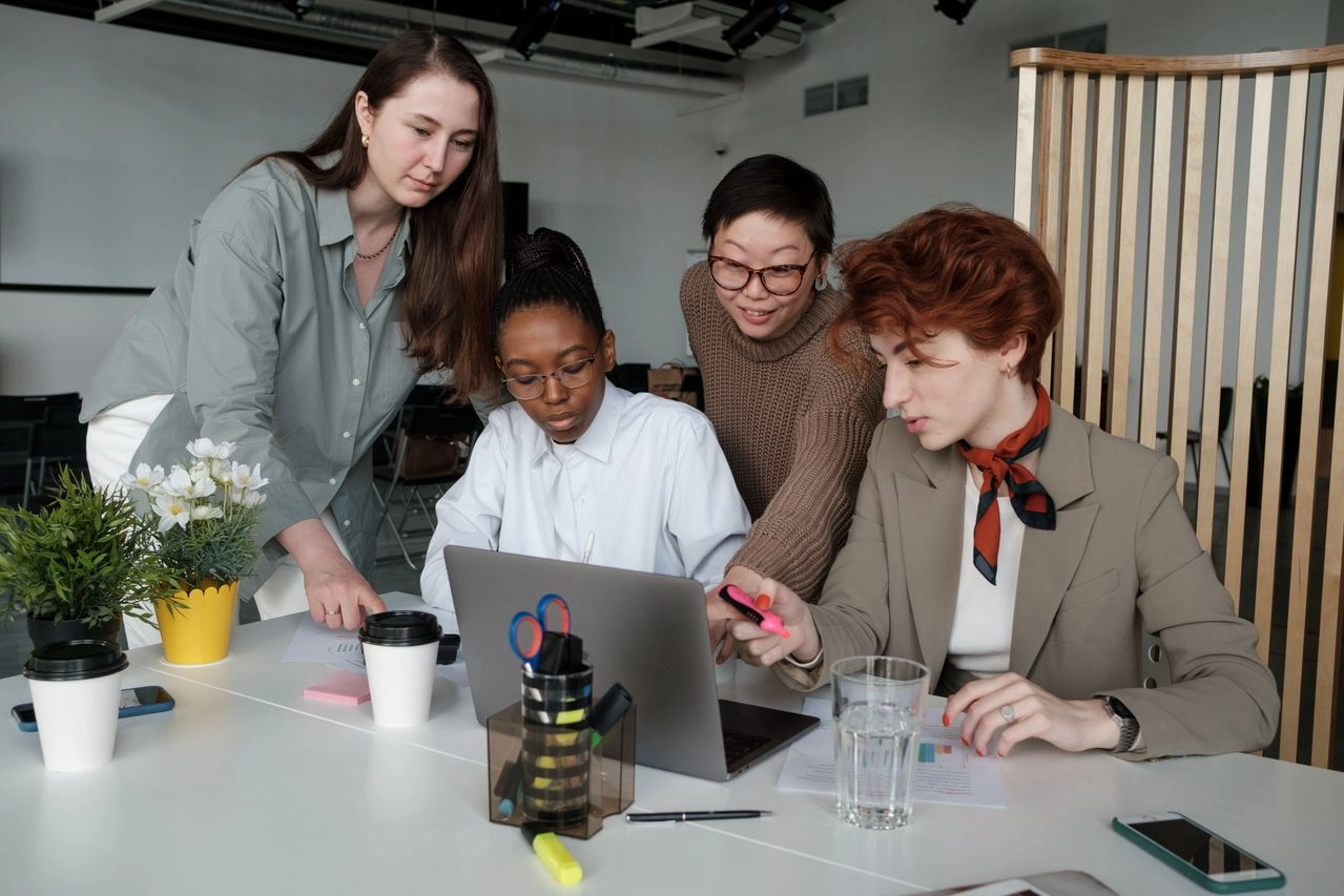 A group of women collaborating together in an office. Cartier Women’s Initiative