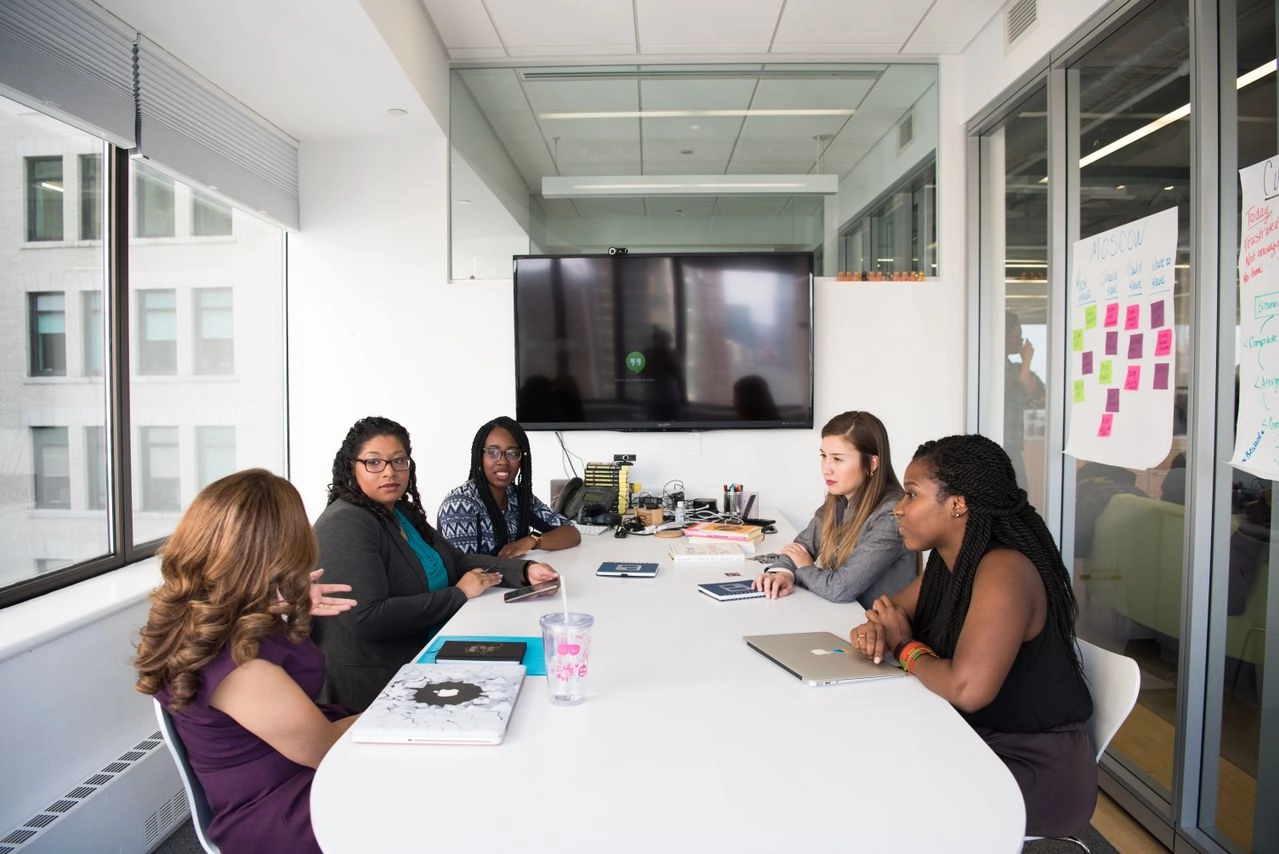 A group of diverse wome working together. Why crowdfunding?