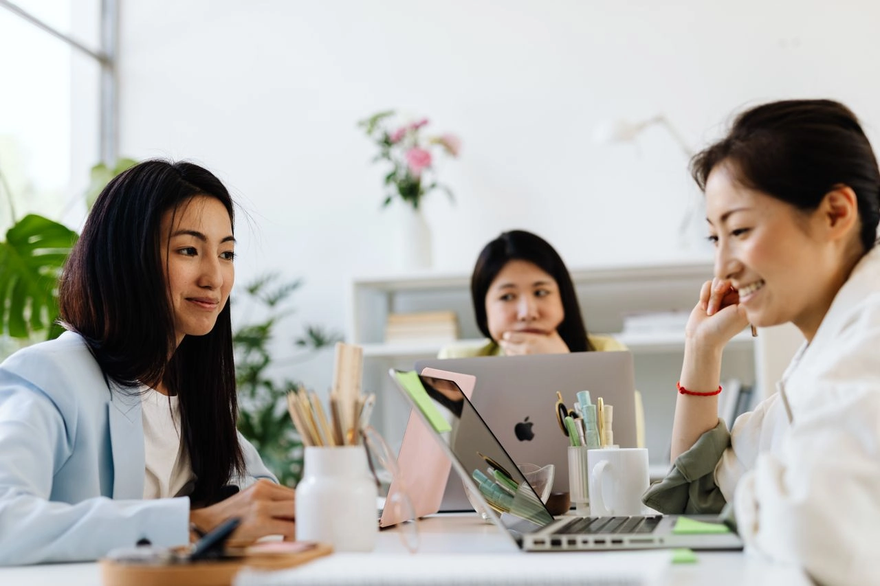 Women collaborating in an office. Grant application checklist