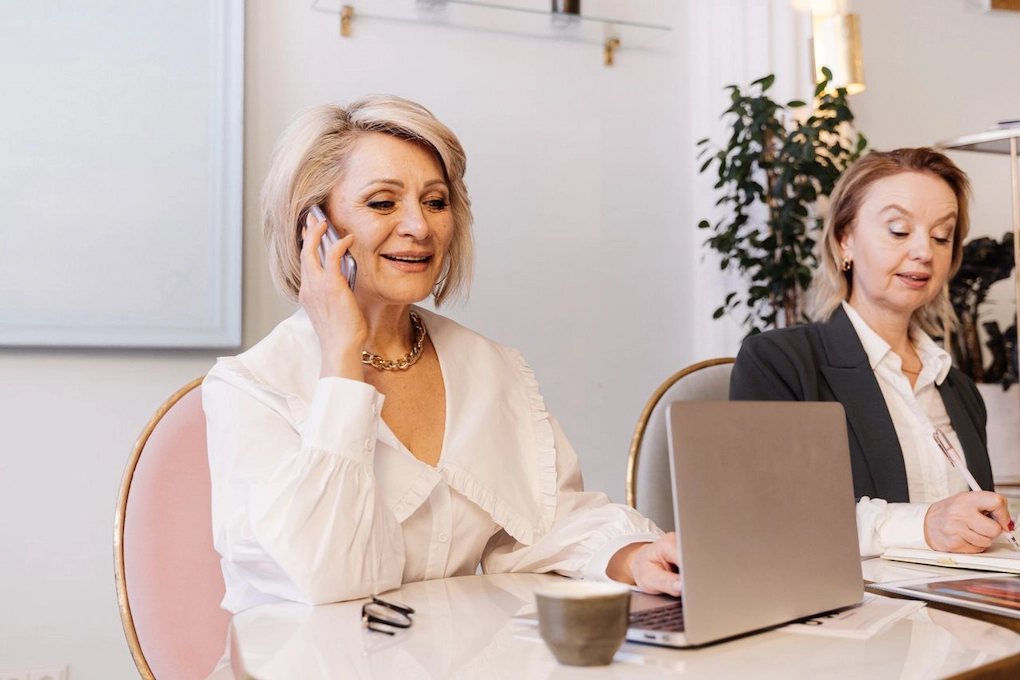 Two businesswomen engaged in work. Business Grants for Women Veterans