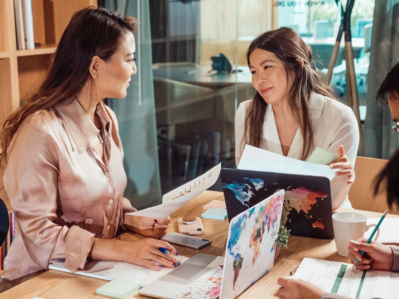 Two women working together in a modern office. How to get WOSB/EDWOSB certified
