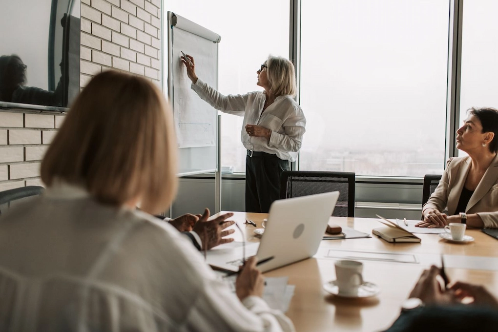 Executive presenting strategy on whiteboard during office meeting. Can you get a business grant with no revenue